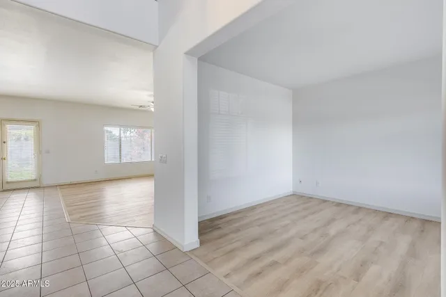 an empty room with windows and white walls