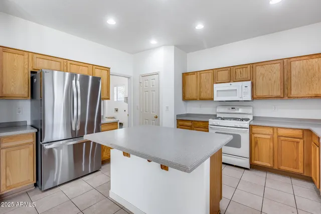 a kitchen with stainless steel appliances a refrigerator sink and stove