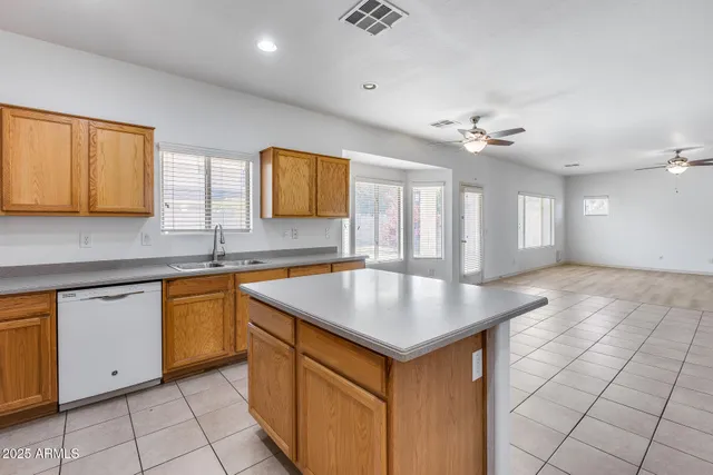 a kitchen with stainless steel appliances granite countertop a sink and a white cabinets