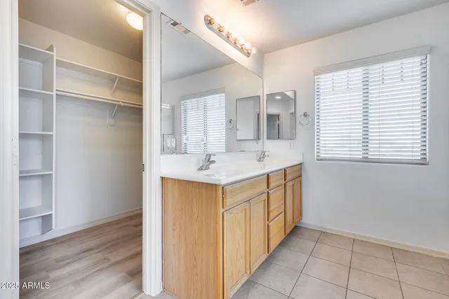 a kitchen with a sink cabinets and wooden floor