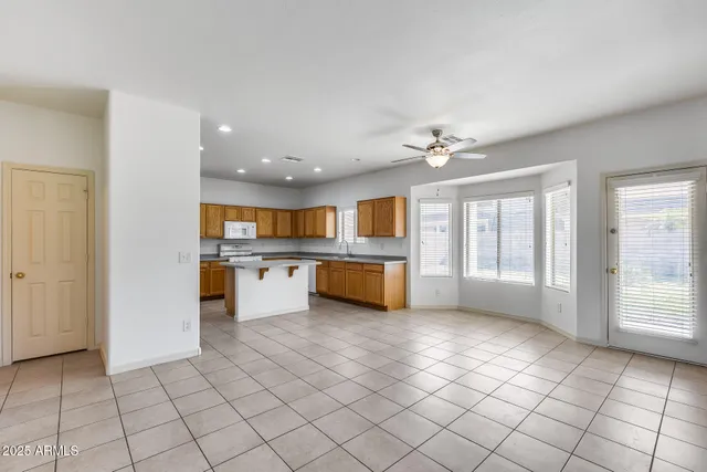 a kitchen with stainless steel appliances granite countertop a sink a stove and a refrigerator