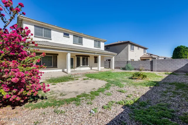 a view of kitchen with windows and refrigerator