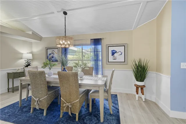 a bedroom with a bed lamp chandelier and a large window