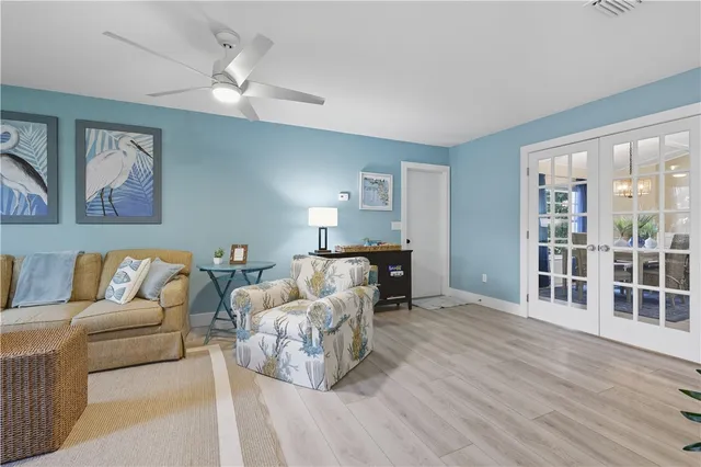 a spacious bedroom with a bed a dresser and a large mirror