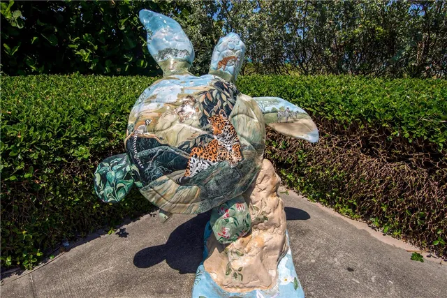 a view of a wooden chairs and fire pit in the backyard