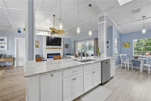 a kitchen with stainless steel appliances kitchen island granite countertop a sink and cabinets