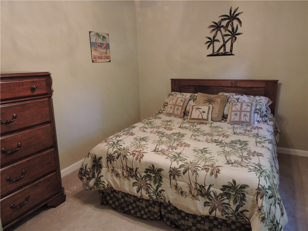 1901 Hattons Ford Road Townville, SC 29689 - Photo 6 of 33 A restful bedroom offers wall-to-wall carpeting and a warm wood headboard.