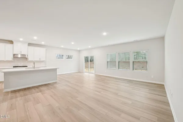 a view of a kitchen with a sink and wooden floor