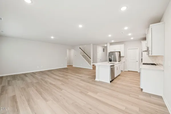 a kitchen with a sink stove and refrigerator