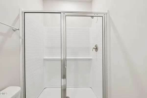 a view of an empty room with a kitchen