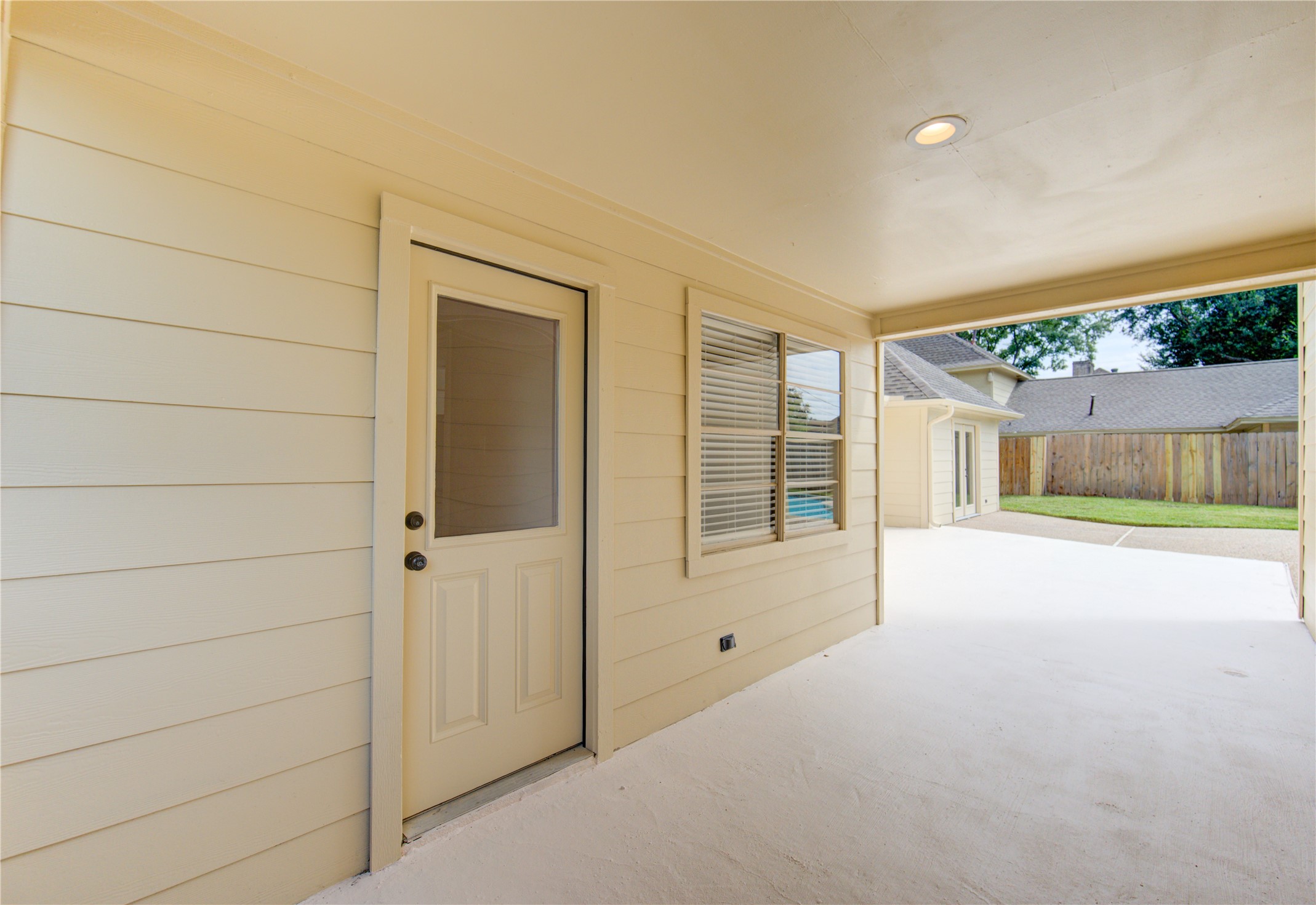 9115 Taidswood Drive Spring, TX 77379 - Photo 42 of 45 Entry to the main house through the laundry room. This covered area is large enough for seating or a small patio table with chairs.