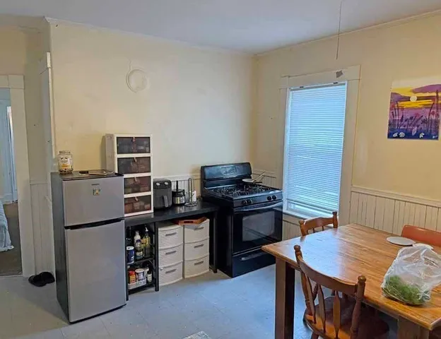 a kitchen with a sink a stove and cabinets