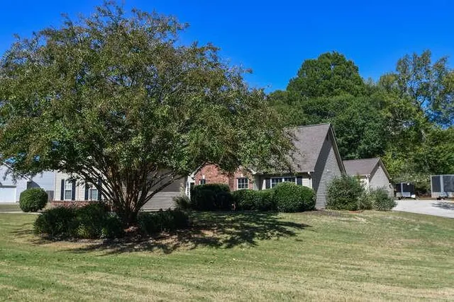 a view of a dining room and livingroom with furniture wooden floor a chandelier