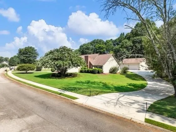 a front view of a house with garden
