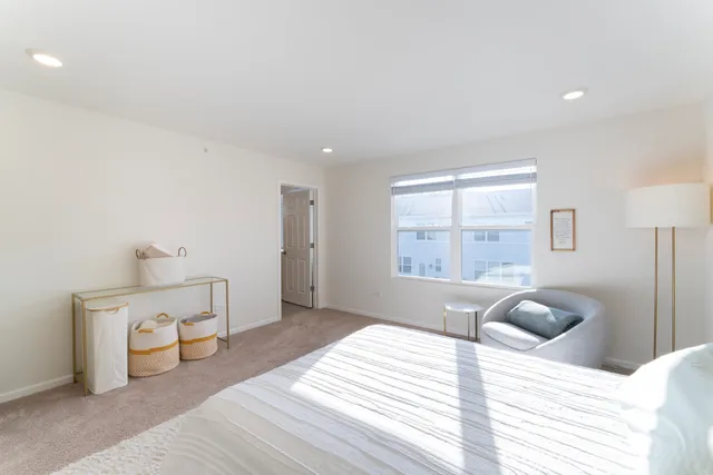 a bedroom with a bed and a large window