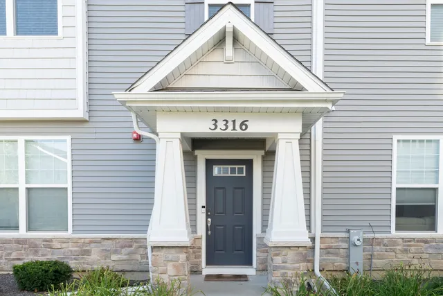 a view of brick house with large windows