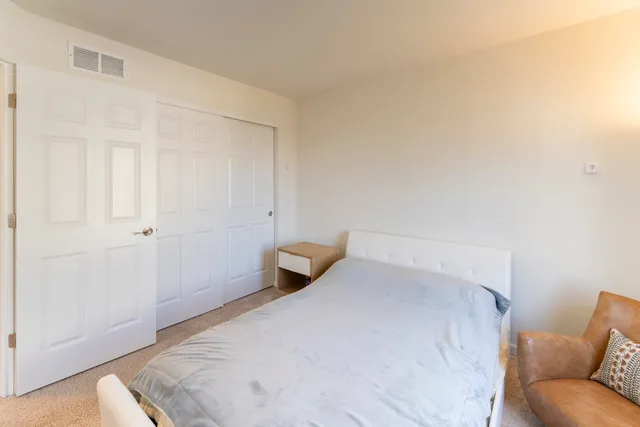 a bedroom with a bed and a couch