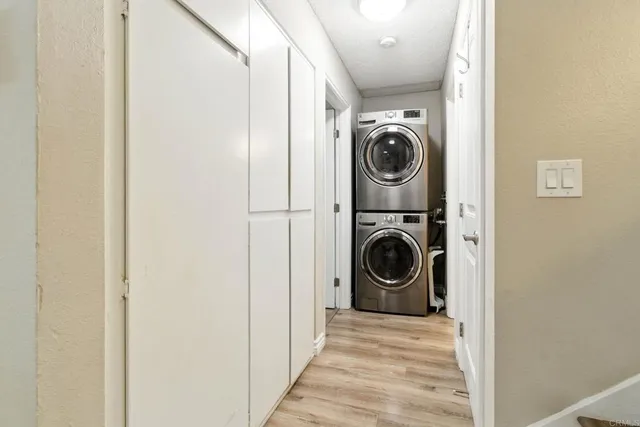 a view of a hallway with washer and dryer