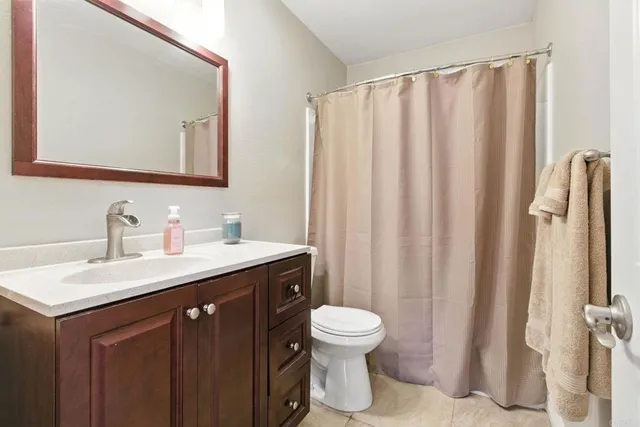 a bathroom with a sink a toilet and mirror