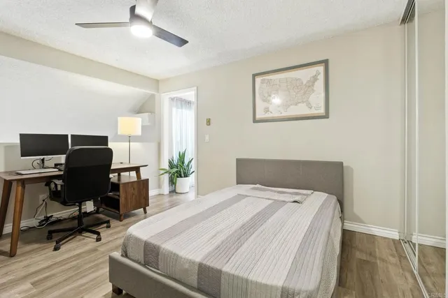 a bedroom with a bed and a desk