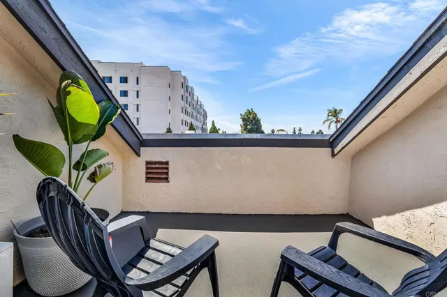 a view of a chairs and table in a balcony