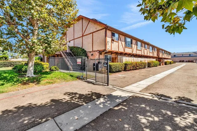 a view of a street with a small yard