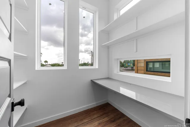 a view of room with window and wooden floor