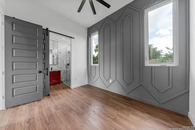 an empty room with windows and closet