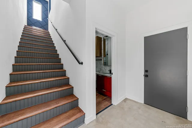 a view of entryway and hall with wooden floor