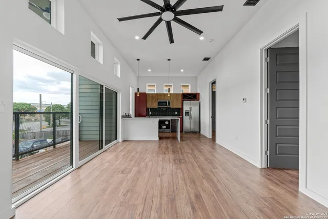 a view of kitchen with refrigerator stove and wooden floor
