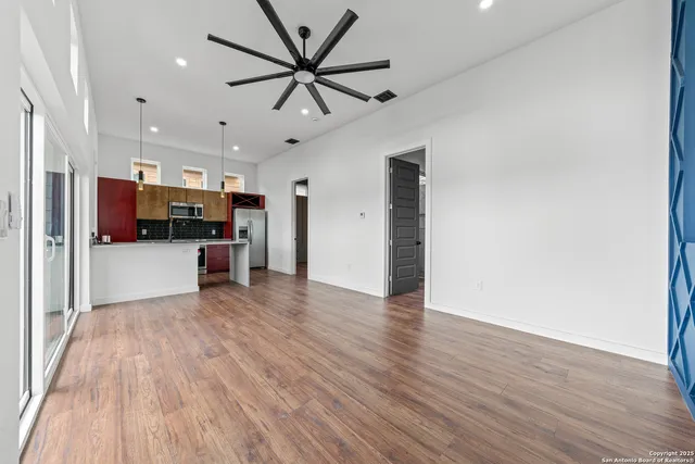 a view of a kitchen with a sink and a refrigerator