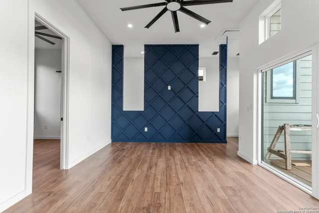 a view of a hallway with wooden floor and staircase