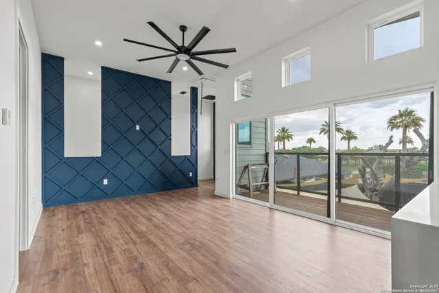 a view of a livingroom with a ceiling fan and window