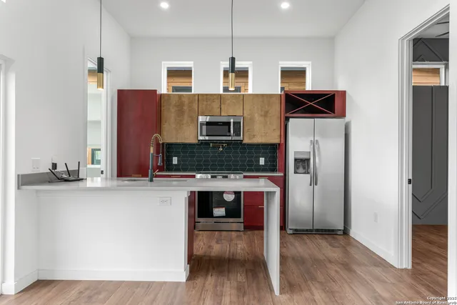 a kitchen with stainless steel appliances granite countertop a stove and a refrigerator