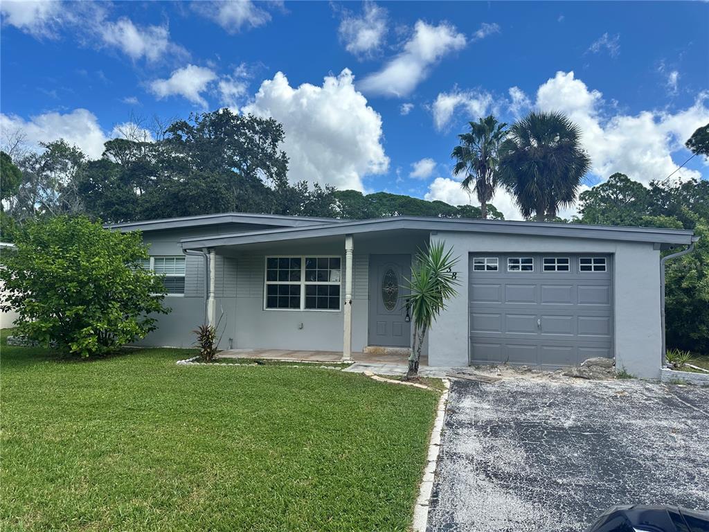7138 Oelsner Street New Port Richey, FL 34652 - Photo 1 of 1 front view of house with a yard