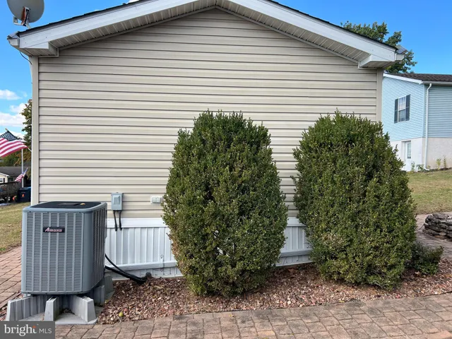 a view of a small house with a garden