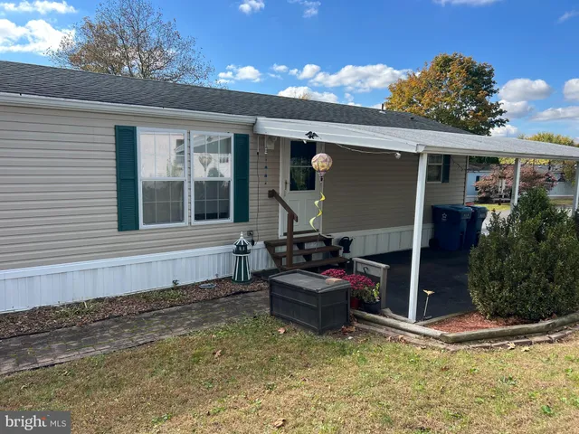 a backyard of a house with yard and outdoor seating