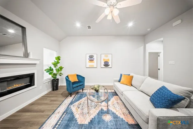 a living room with furniture and a fireplace