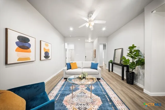a living room with furniture and a chandelier
