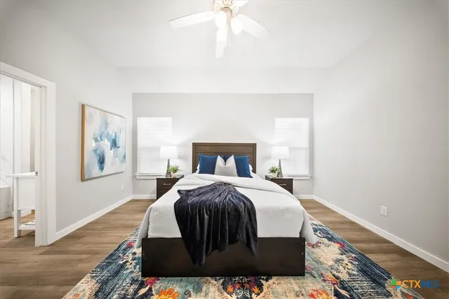 a bedroom with a bed and a painting on the wall