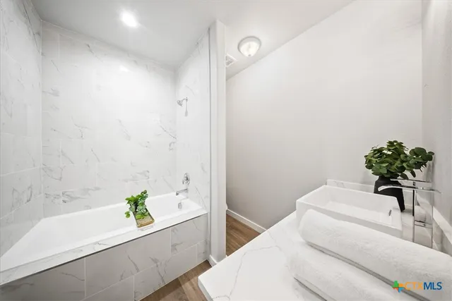 a bathroom with a bathtub and a sink