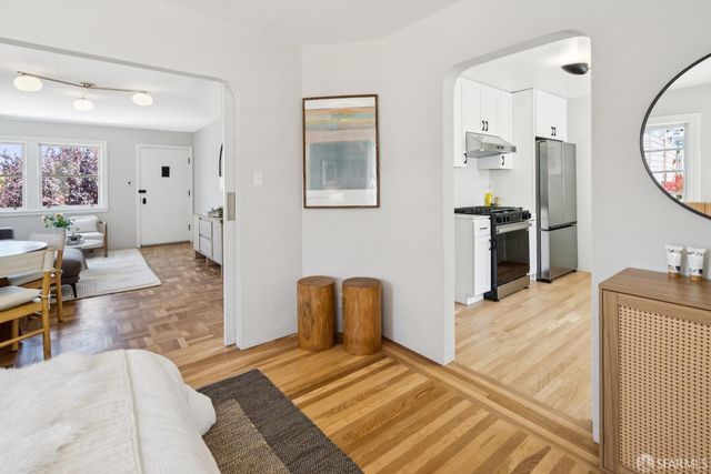 a spacious bedroom with a bed a couch and dresser