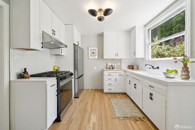 a kitchen with stainless steel appliances granite countertop a stove and a sink