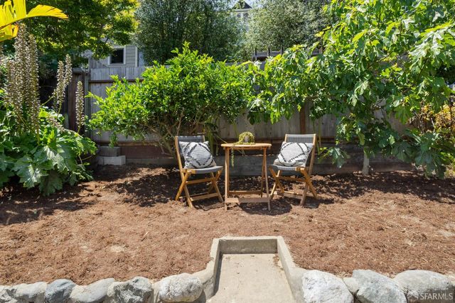 a view of a backyard with sitting area
