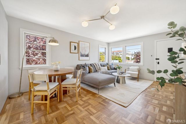 a living room with furniture and a chandelier