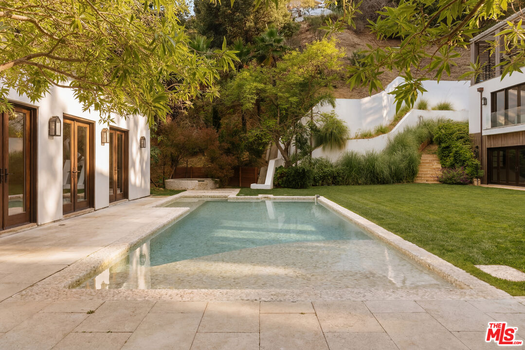1105 Rivas Canyon Road Pacific Palisades, CA 90272 - Photo 44 of 49 a view of backyard with swimming pool and seating