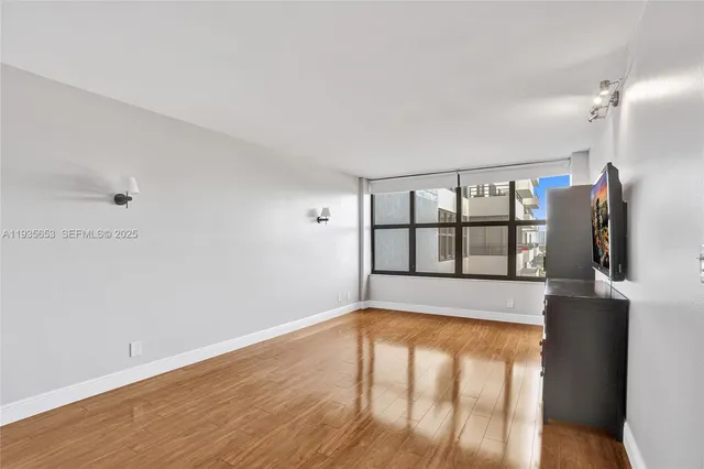a view of an empty room and wooden floor