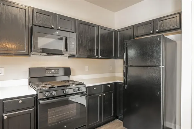a kitchen with appliances and cabinets