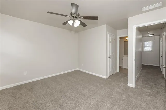 an empty room with a chandelier fan