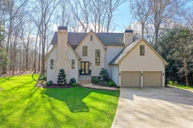 a backyard of a house with a fire pit and outdoor seating